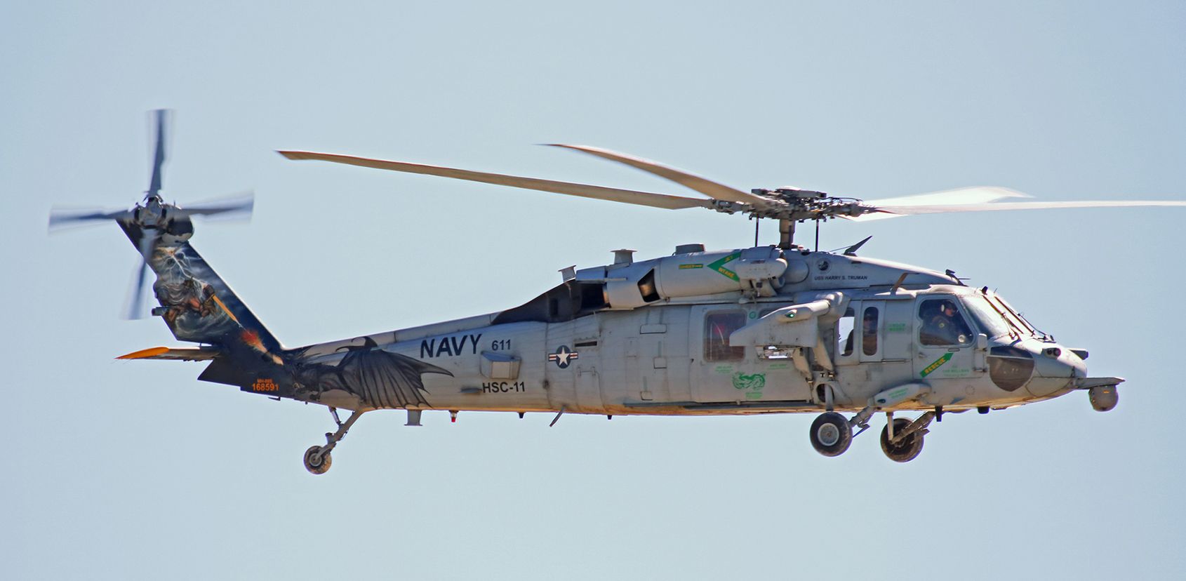 Sikorsky S-70 (16-8591) - Crewmen aboard the Helicopter Sea Combat Squadron Eleven "Dragonslayers" colorbird, a Sikorsky MH-60S, look down at us as we photograph them while they are arriving at NAS Fallon to begin training exercises. HSC-11 arrived yesterday (Apr 29, 2019) from NAS Norfolk and is assigned to Carrier Air Wing One (NAS Oceana), USS Harry S. Truman (CVN-75).