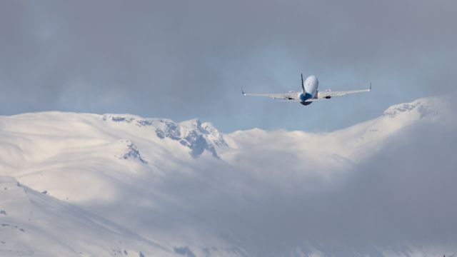 Boeing 737-700 (N615AS) - Alaska flight 61 departing Juneau for Yakutat.  I was on the wetlands south of the airport, so on the wrong side.  The Chilkats are in the background.