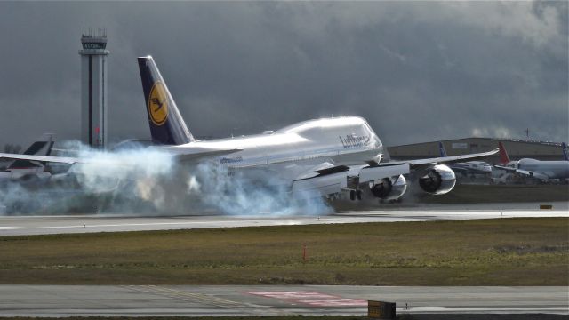 BOEING 747-8 (D-ABYG) - BOE26 makes tire smoke on landing runway 16R to complete a flight test on 1/25/13. (LN:1470 c/n 37831).