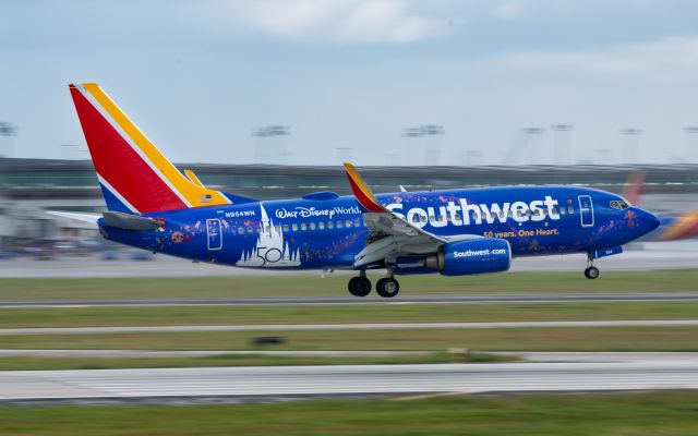 Boeing 737-700 (N954WN) - Southwest Airline's latest special livery, celebrating 50 years of partnership with Disney, arrives from New Orleans into Houston Hobby on a wet 30 Sep 2021 morning.  Taken from 1940 Air Terminal Museum balcony.