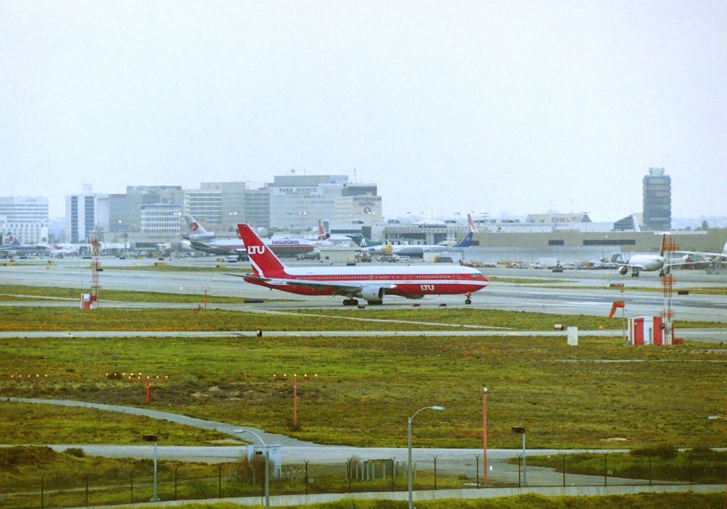 BOEING 767-300 — - KLAX - I'll look the reg up later, but an easterly view from "Hooker Hill" towards 24L and LAX in the distance. I had the 8ft ladder in the back of the pick up truck and the "clientele" that would drive up (usually a male and female) and park a little too close for me, and leave 15 mins later and the "dealers" in their cars made me not want to take photos from here. I did get some good video here one day in 1998 on a rainy day of 6L arrivals from over the Pacific Ocean behind the camera view. This area closed off long ago...