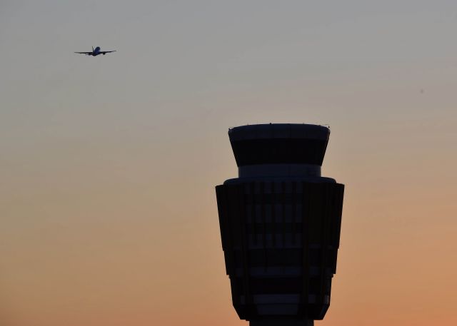 — — - Tower shot at sunset with a AA Airbus departing to the west.