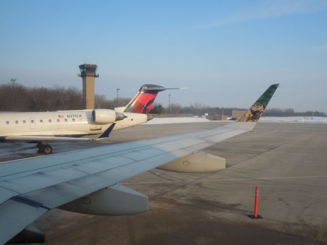 Canadair Regional Jet CRJ-700 (N371CA) - Taken from a Frontier E-190 (N167HQ) preparing to depart to DEN on a cold February morning , the Delta CRJ-700 was going to LGA.