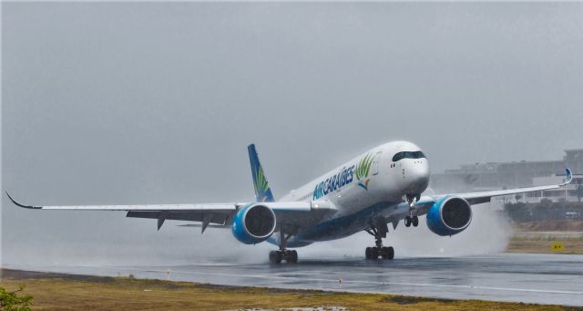 Airbus A350-900 (F-HNET) - Air Caraibes A350-900 touching down for the first time on St Maarten with A 350-900.