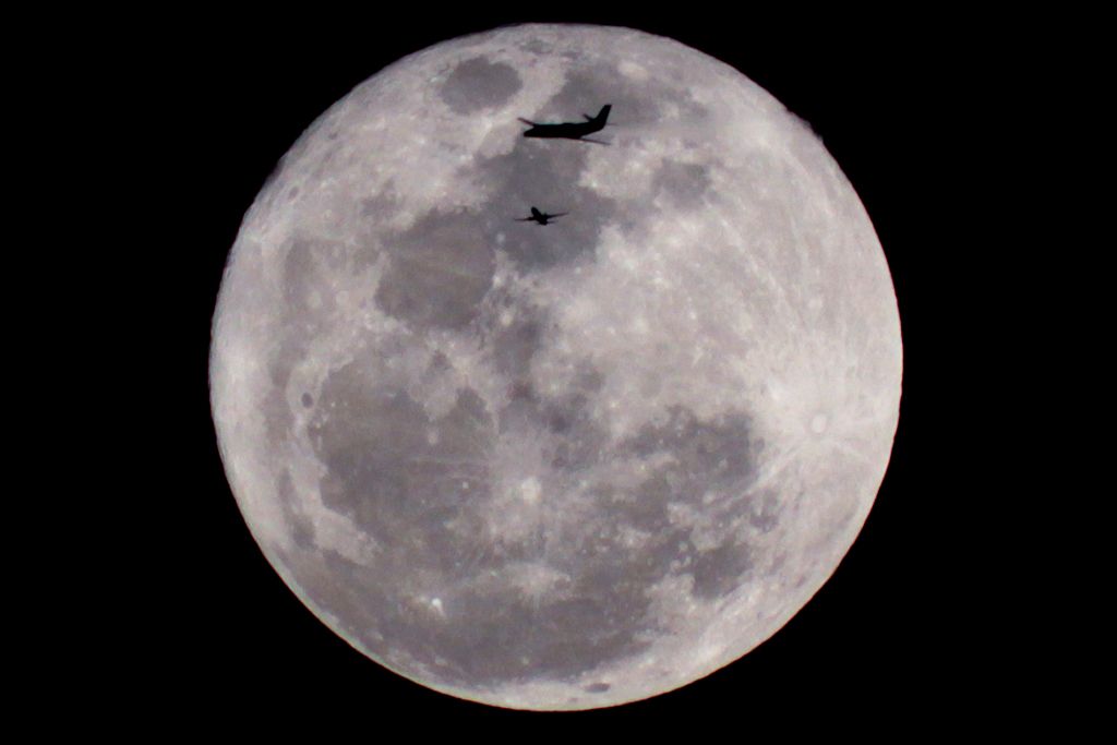 — — - Was taking pictures of the Super moon on March 19, 2011 and saw the blinking lights of a plane heading towards the moon. I snapped a series of photos as it crossed in front of the moon, then once I looked at the photos on the computer, noticed there was a second plane flying in front at that exact moment. The shot was handheld with a kit lens so the quality is not 100%, but it's definitely the luckiest photo I've taken.