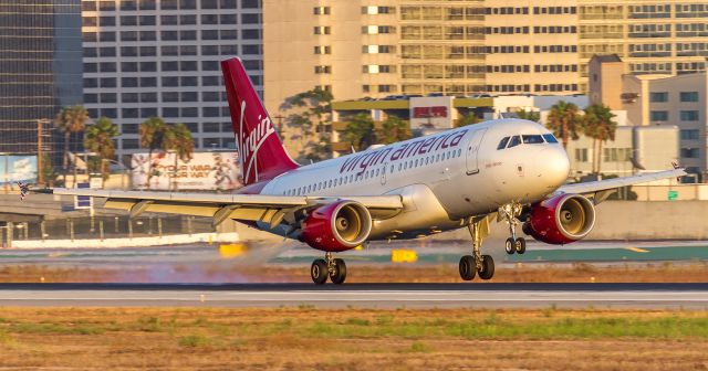 Airbus A319 (N530VA) - godo dancer just touching down on runway 24R at LAX. Taken from the Westchester bridge late afternoon.