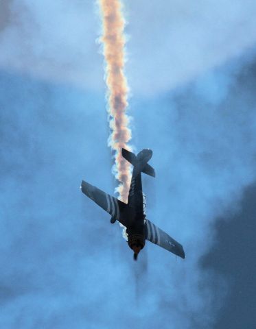 YAKOVLEV Yak-52 (VH-YRO) - Immersed in his own smoke during airshow routine - I enjoyed the effect of the sun behind the plane and smoke and the shadows it created