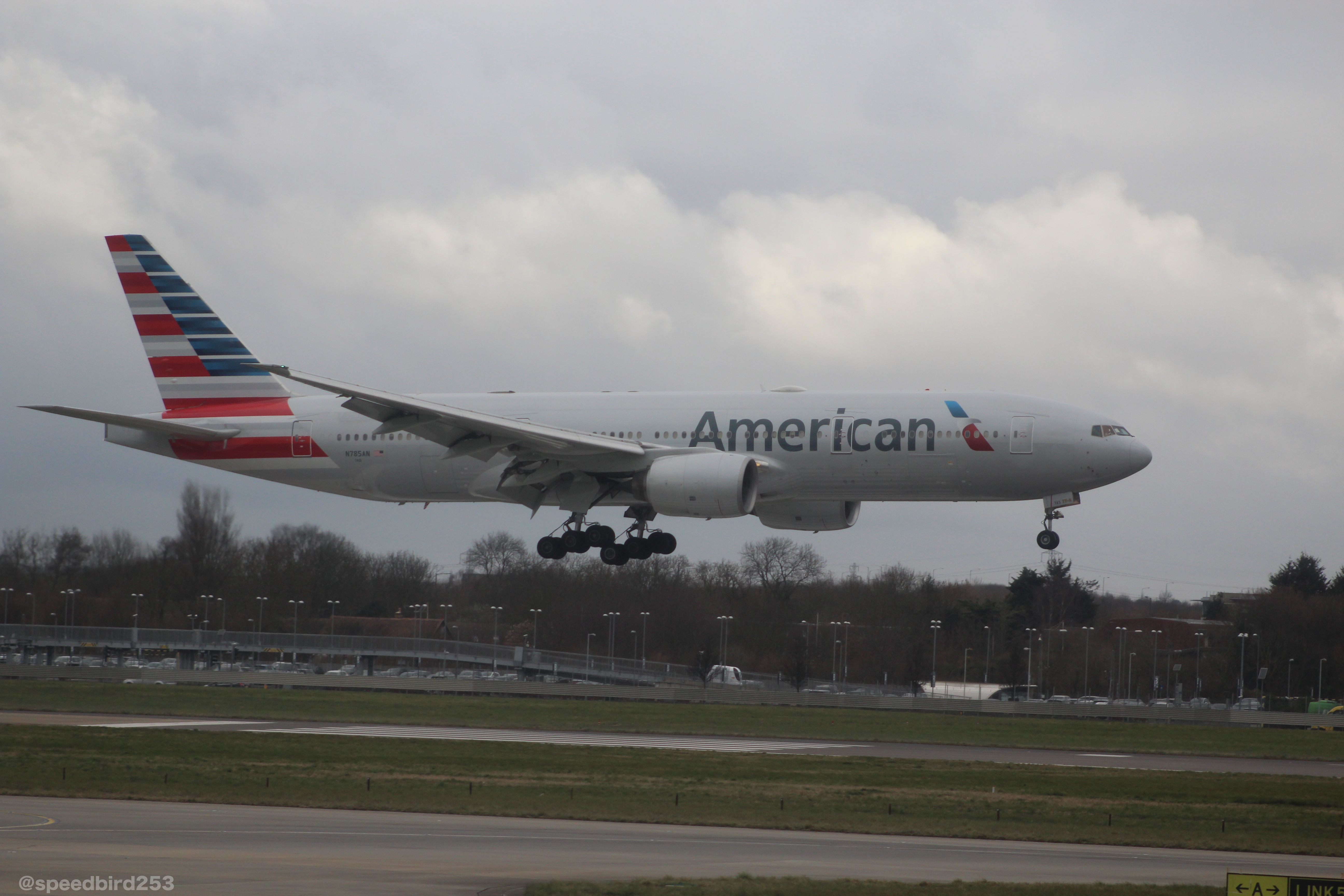 Boeing 777-200 — - At a gate by 09L, American 777 landing on 09L after a flight from KJFK