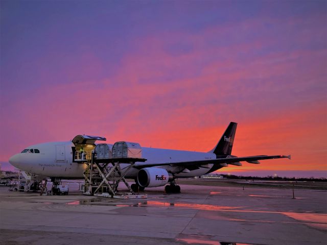 Airbus A300F4-600 (N670FE) - A rose colored sky shimmers off Flight 325's fuselage on 3-17-21. Flight 325 has just arrived from Fargo, ND and will have empty containers off loaded and full containers loaded in less than 45 minutes. Then ready for a punctual departure to Madison, WI