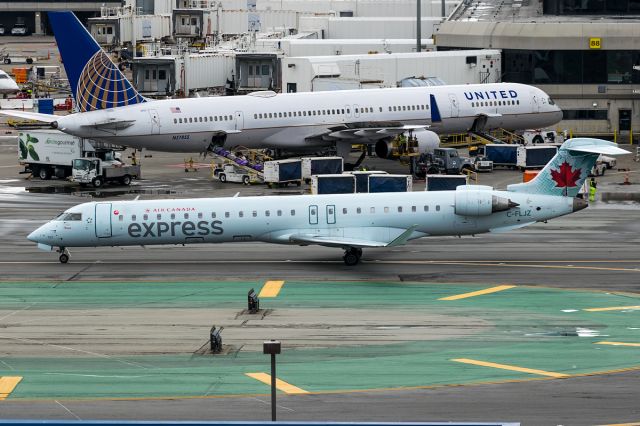 Canadair Regional Jet CRJ-700 (C-FLJZ) - Air Canada being watched over by Uniteds 757