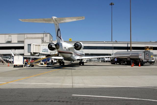 Canadair Regional Jet CRJ-700 (N603QX) - KSFO - drive by view of N603QX in July 2009 - at the gate. Delv to Alaska on 11/8/2001 a mere 23 years plus a few days ago, now shows flying with Go Jet as N502GJ. 