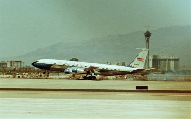 Boeing 707-100 — - KLAS - I'm not good at Military registration IDs - any help is appreciated. This should be July 1995 with VP Al Bore arriving for a Las Vegas Conference. I tried 6 times to level this photo w/my crummy editing tool - the Stratosphere looks OK but the runway does not. C-137B..?? arriving 25R on a very warm July 1995 - an aviation photog friend was on my ladder, I shot through the fence.I had never seen this tail number but sure was neat to see it land! Note, the crane atop the then under construction "Stratosphere Tower" at 1100ft....believe it or not, they hoist another crane parked below, add extensions, one after another,( yes it is a long street ) and the rig was maybe a 6-axle Bigge Crane type rig, and they actually raised the rigging all the way up to then top crane, to dismantle the construction crane atop the tower. The last time I was up in the Stratosphere Tower was March 2001, and when I walked out the elevator to the rim to take photos, the wind was blowing quite a bit harder than when we parked below. I made an immediate U-Turn and back to the elevator, as the top end was swaying so much I freaked out. The guy in the elevator said I pretty much tied the record for people walking off the elevator and turning around to get off the top, back on the elevator and down!! ;..LOL!!!!!