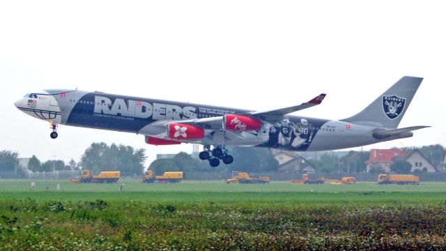 Airbus A340-300 (9M-XAC) - Landing. August 2011 memory.Livery"proud of sponsor of the oakland raiders"