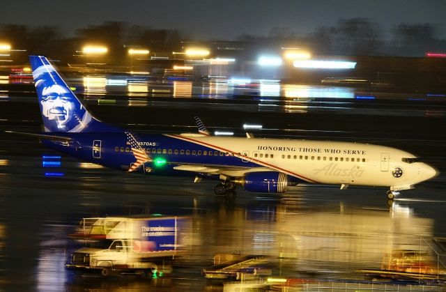 Boeing 737-800 (N565AS) - Taxiing to gate 11 in heavy rain after arriving from Seattle, WA