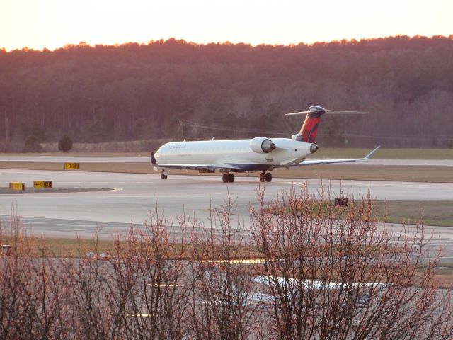 Canadair Regional Jet CRJ-900 (N187GJ) - A Delta Connection (GoJet) Bombardier CRJ-900 landing at Raleigh-Durham Intl. Airport. This was taken from the observation deck on January 18, 2016 at 5:22 PM. This is flight 6229 from TPA.