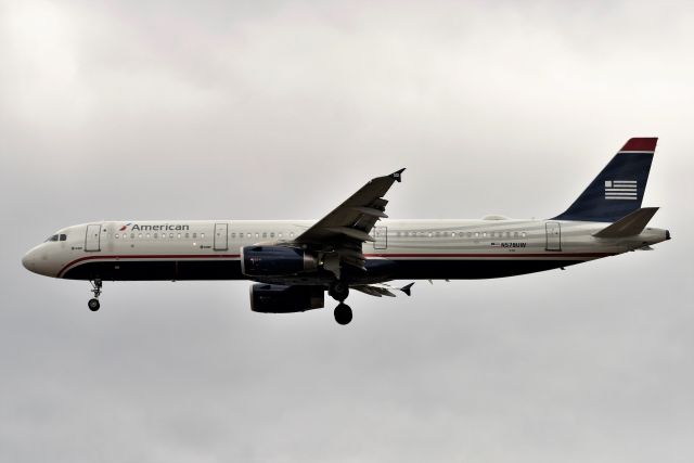 Airbus A321 (N578UW) - US Air Heritage Jet landing 23-R 02-16-22 under heavy overcast.