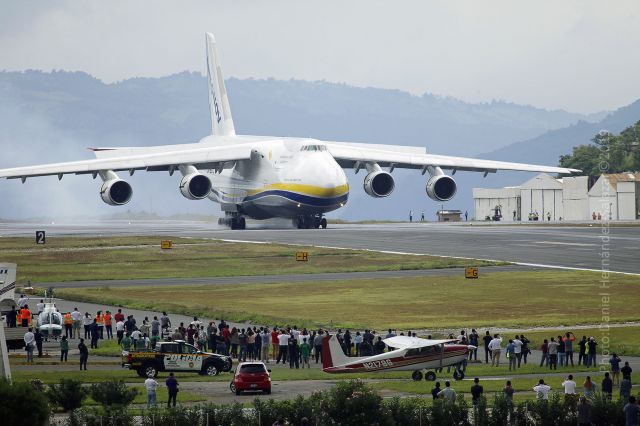 Antonov An-124 Ruslan (UR-82072) - Hundreds of people observe an Antonov 124 lands at Guatemala City's International Airport transporting helicopters and other anti narcotics equipment. 