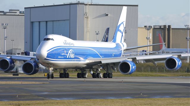 BOEING 747-8 (VQ-BLQ) - BOE602 rolls from the taxiway onto runway 16R for its maiden flight on 12/21/11.