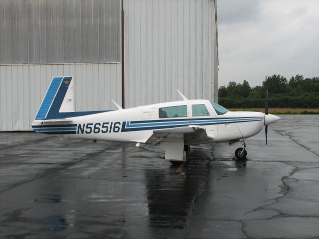 Mooney M-20 (N56516) - Sitting on the ramp in a rain storm.