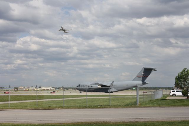 Boeing Globemaster III (N60006) - A American Eagle E175 taking off over a C-17