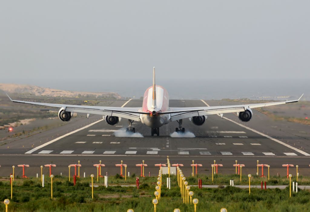 Airbus A340-600 (EC-IOB) - Touchdown on the runway 03L.