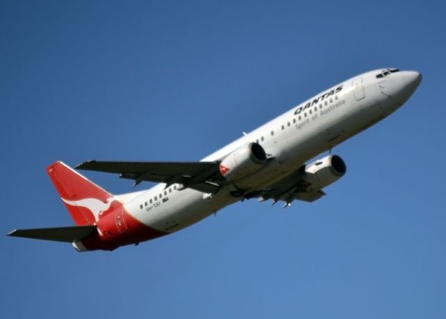 BOEING 737-400 (VH-TJU) - Undercarriage retracted and climbing steeply off runway 23.