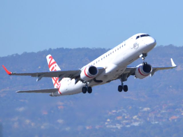 Embraer ERJ-190 (VH-ZPT) - Getting airborne off runway 23 on a beautiful Adelaide autumn day. Thursday 12th April 2012.