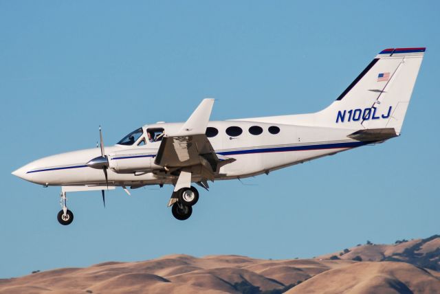 Cessna Chancellor (N100LJ) - N100LJ with the beautiful backdrop of San Joses golden brown hills.