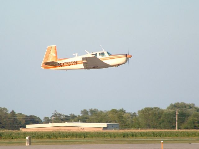 Mooney M-20 (N2701W) - Departing Airventure 2006 Rwy 17.  Evening sunlight. Photo by Tom Wadsworth