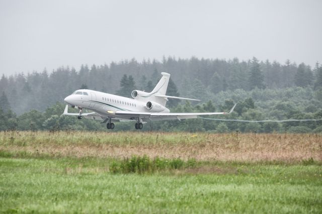 Dassault Falcon 7X (N501PG) - Arrival in the forest. Rain and deep clouds... The terrain enables some rare perspectives.