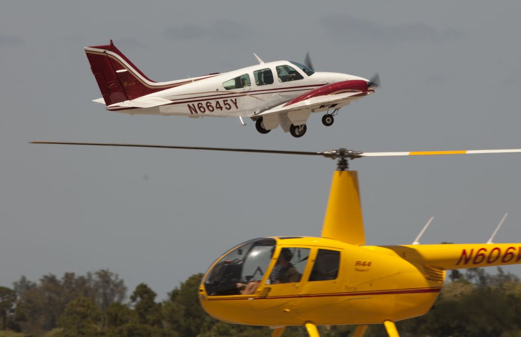 Beechcraft 55 Baron (N6645Y) - The camera perspective s misleading. It was a safe spacing between the fixed wing and the helicopter.
