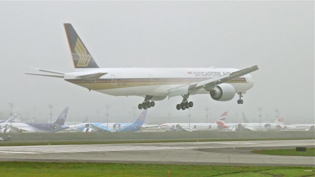 BOEING 777-300 (9V-SWV) - BOE292 on final approach to Rwy 16R on a foggy 9.13.13. (LN:1136 cn 42236).