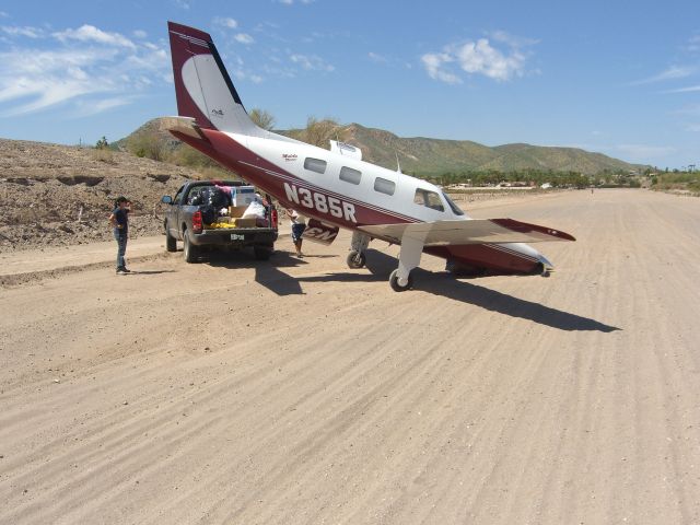 Piper Malibu Mirage (N385R) - Muleje MX, flying hurricane relief support.  Nose actuator folded.