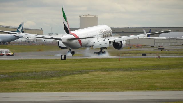 BOEING 777-300 (A6-EGV) - BOE200 touching down on runway 16R to conclude of its first flight on 7/23/12. (LN:1031 c/n 38990).