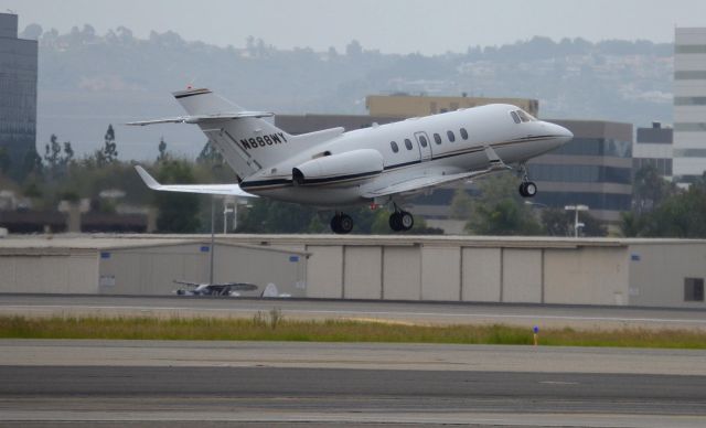 Hawker 800 (N888WY) - N888WY is seen just after rotation from runway 20R. Photo was taken from the Lyon Air Museum parking lot.