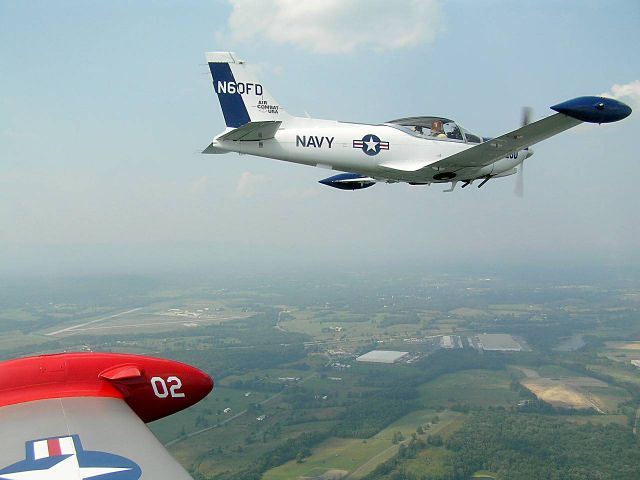 N60FD — - Marchetti SF 260 of Air Combat USA flies in formation with sister ship N272C on approach to runway 26, Orange County Airport, following mock dogfight.