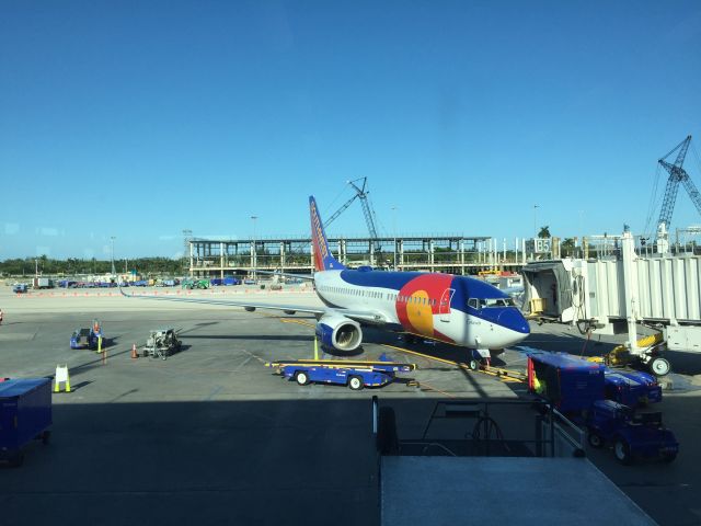 Boeing 737-700 (N230WN) - Southwests "Colorado One" in front of the new A concourse being built at KFLL.