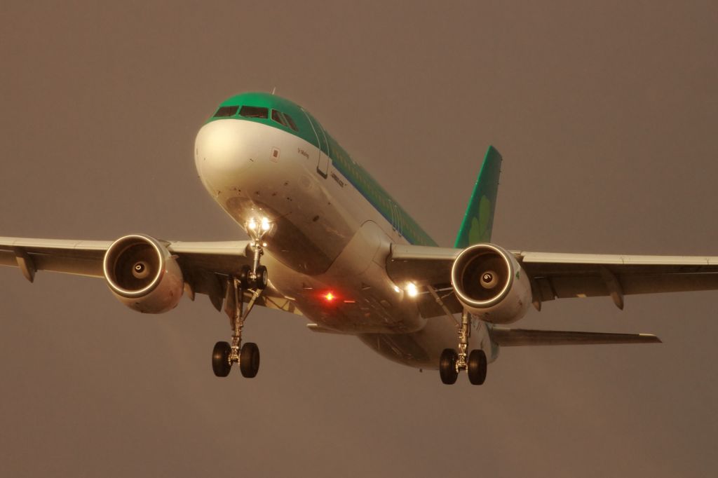 — — - An Aer Lingus A320-200, approaches runway 027R at LHR during a sunshower.