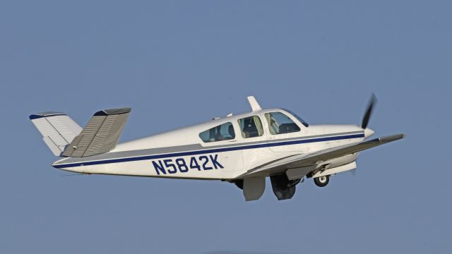 Beechcraft 35 Bonanza (N5842K) - Departing AirVenture on Runway 18R