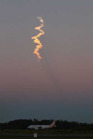 Airbus A319 (N822AW) - 10/08/22 American lands on Rwy 35R at sunset under the vapor trail of a just launched Spacex Falcon rocket. 