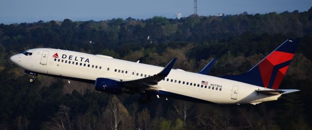 Boeing 737-800 (N371DA) - Delta 738 departing off of 23R in the early morning sun, from the top of the RDU parking deck, 4/14/18.