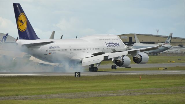 BOEING 747-8 (D-ABYC) - BOE23 makes tire smoke on touchdown to runway 16R completing its maiden flight 6/7/12. (LN:1451 c/n 37828).