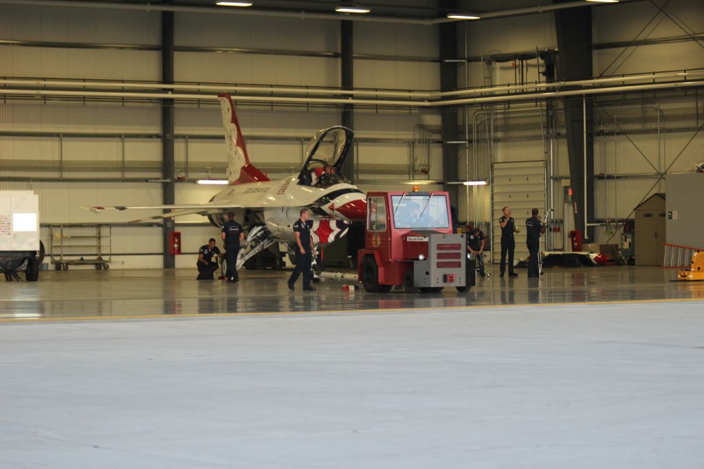 Lockheed F-16 Fighting Falcon — - T-Birds crew working late into Saturday evening on Thunderbird 1 in the Gary Jet Center Hanger 3, long after the crowds went home. 