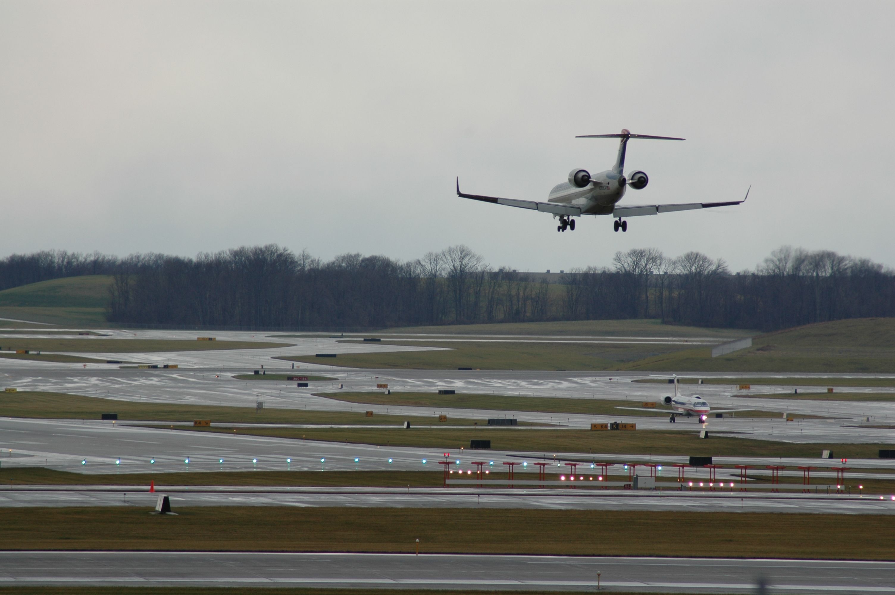 Canadair Regional Jet CRJ-700 (N369CA) - landing on runway 27 with a eagle jet holding