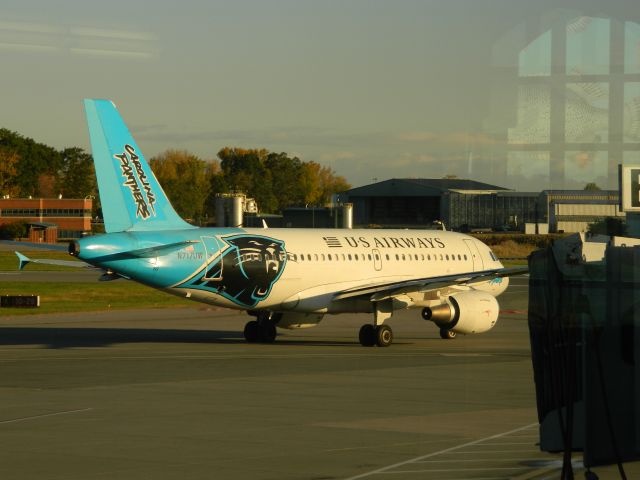 Airbus A319 (N717UW) - A US Airways A319 in the Carolina Panthers livery taxis to Runway 19 for an early departure to Charlotte. 