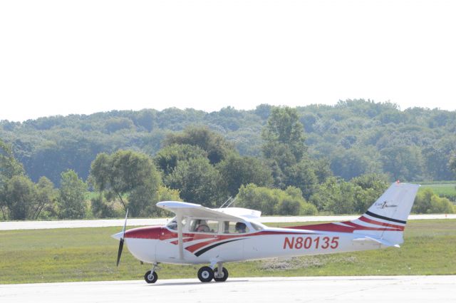 Cessna Skylane (N80135) - N80135, a 1975 Cessna 172M owned by Central Iowa Aviation LLC and used by Exec 1 Aviation, is taxing out to runway 18 for a training flight.  Photo taken July 15, 2017 with Nikon D3200 mounting 55-200mm VR2 lens.