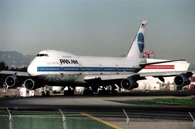 Boeing 747-200 (N728PA) - KSFO - N728PA Clipper Water Witch - well traveled and well worn - this Pan Am workhorse moves to Runway 1 R at SFO- and I do not remember where the 747 was headed. My guess would be Europe or LHR.