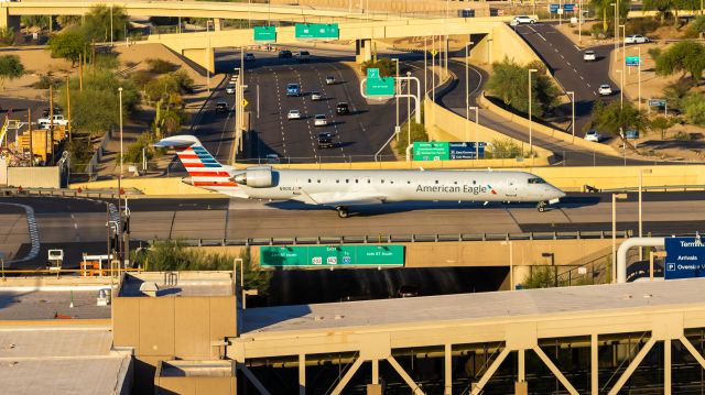 Canadair Regional Jet CRJ-900 (N905J) - American Airlines CRJ-900 taxiing over the highway at PHX on 7/7/22. Taken with a Canon 850D and Rokinon 135mm f/2 lens.