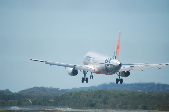 Airbus A320 (VH-VFD) - Taken moments before touchdown into runway 14 at YBCG on a beautiful sunny day. 