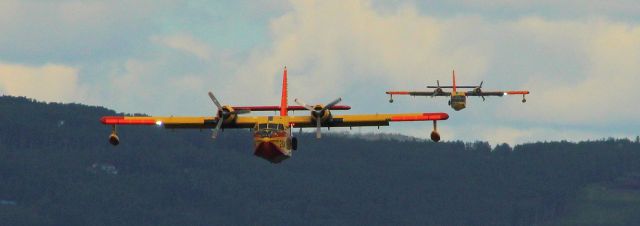 — — - CL-215's lined up on final to float pond to pickup water for forest fires close by.